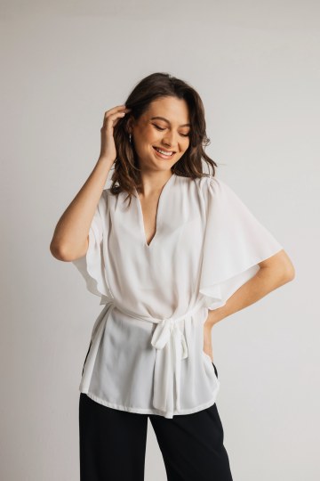 Μπλούζα αέρινη με μανίκι και ιδιαίτερες λεπτομέρειες στους ώμους λευκή.